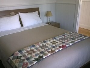 The main bedroom has a queen-size bed with superior bed bedding and a heater.