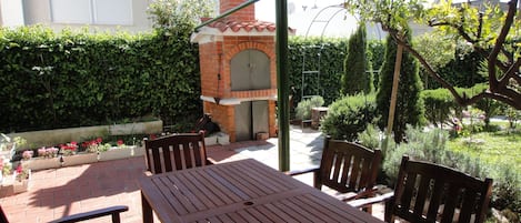 Giardino, barbecue, guarnitura all'ombra 