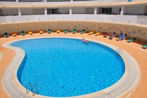 swimming pool with sunbeds
