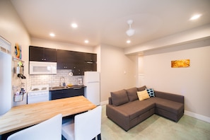 View into the living room/fully stocked kitchen for cooking