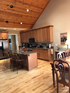 Granite countertops and stainless steel appliances highlight the kitchen area