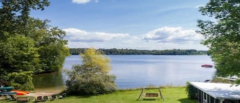 lawn and boathouse with canoes and kayaks