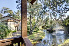 Lagoon View from 406 Harbour Oaks - Take in the peaceful view of fountains and moss-draped oaks from the balcony at 406 Harbour Oaks, where lush landscaping winds through the quiet gated community.