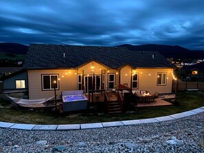 Backyard oasis complete with hammock, hot tub, and fire pit!