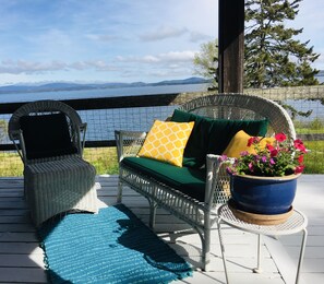 Oceanfront sunny deck. Generous proportions, wraps around two sides. 