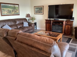 Living room with dual recliners and a smart tv