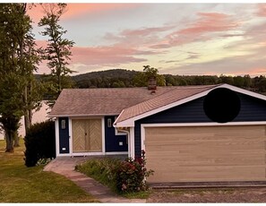 View from street to front of the house, automated garage and keyed door entry