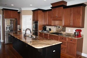 Large, well equipped custom kitchen with ample counter space and large island.