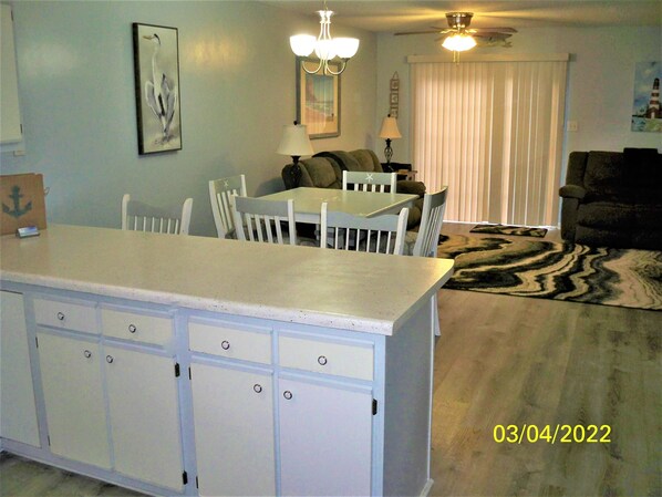 View from the front door looking at kitchen bar, dining area and living room.