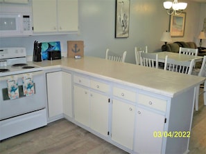 Kitchen bar with refinished countertop and bar stools.