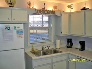 Kitchen with refinished countertop and above cabinet lighting.