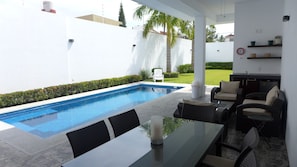Private and heated 270 square feet pool,  terrace with dining and seating set.