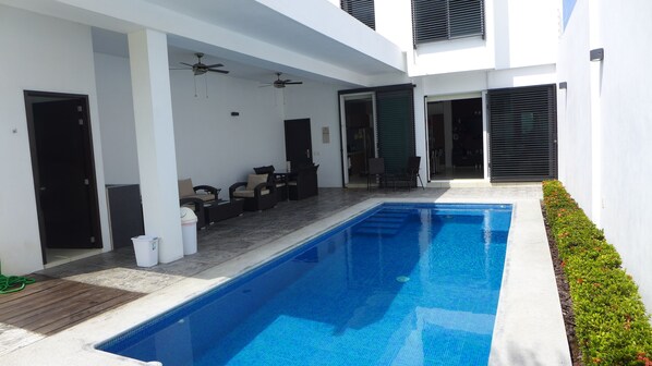 Private and heated 270 square feet pool,  terrace with dining and seating set.