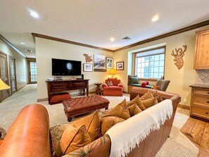 Cozy seating and a giant TV make for a perfect space to gather
