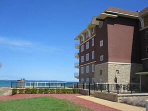 Side view of the building, looking past the pool onto the beach.