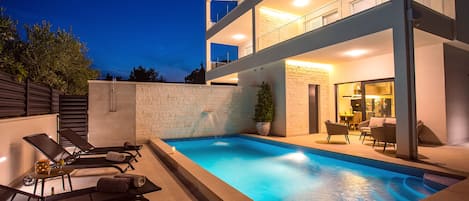 Seafront Villa Petra in the evening with beautiful lights & heated Pool