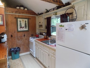 Galley kitchen open to living room.