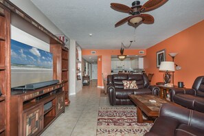 Living room with large TV and sofas