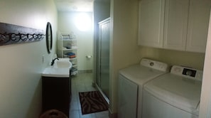 Downstairs bathroom with walk in shower, washer and dryer.