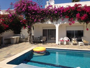 Swimming pool /some tables long chairs BBQ lovely flowers 
