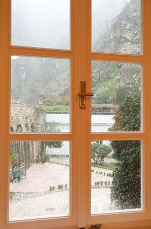 Windows in the kitchen and living room have views towards an open park/square