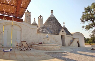 Villa of 4 conical roofs (trullo), fully renovated in big property. Sea view