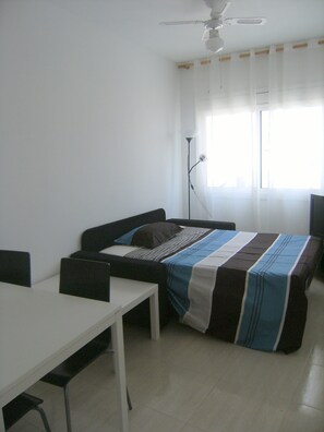 Living room with sofa bed and ceiling fan