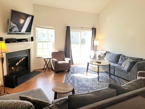 Living room w/ sliding door to deck and yard.