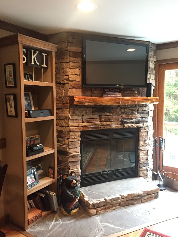 NEW wood burning fire place w/ large flat screen tv & entertainment center!