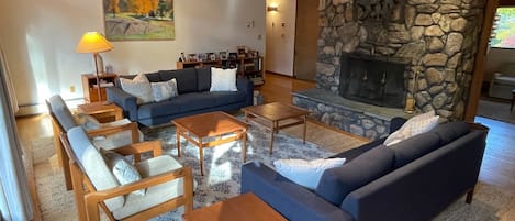 Living room with stone surround fireplace