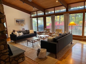 Light-filled living room with new couches and area rugs.