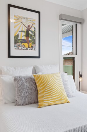 Light filled bedroom with queen bed