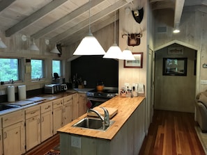 Kitchen, opens to living room.