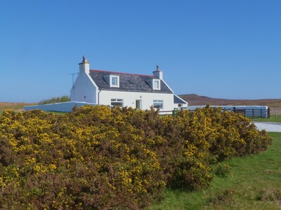 Traditionelles Hochlandhaus mit atemberaubendem Panoramablick auf die Berge und das Meer