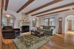 Cozy living room with gas burning fireplace. Window seats. French doors to deck.