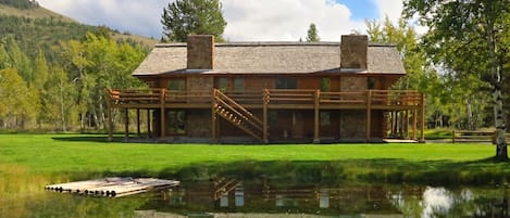 Custom built log cabin with pond situated on 4 pristine acres