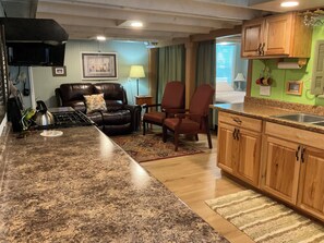 Living room has electric reclining loveseat , two chairs and two stools