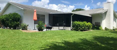 Backyard features a screened in porch & an open area porch w/ fireplace.