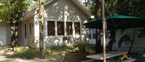 Tree Shaded Cabin with picnic table and fire-pit with lake view.