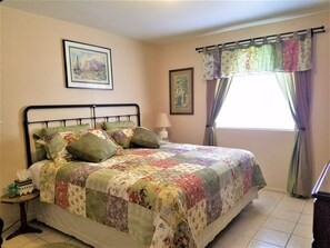 Master Bedroom with bath is done in Old Ranch Style with antiques.