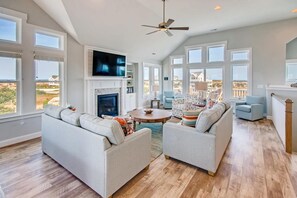 The top level great room features phenomenal ocean views, upscale furnishings, and a large screen TV.