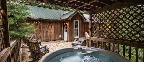 Modern hot tub just a few feet from the front door with gazebo overhead