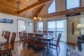 Dining area with patio doors to the deck, overlooking the lake