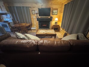 View of electric fireplace w/ real flames and heat.  