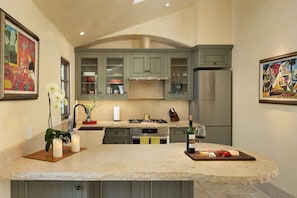 A fully-equipped chef kitchen with Nespresso machine, French press...