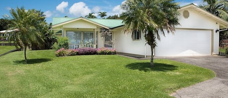 Beautiful tropical bungalow with manicured fenced lawn and a 2 car garage. 