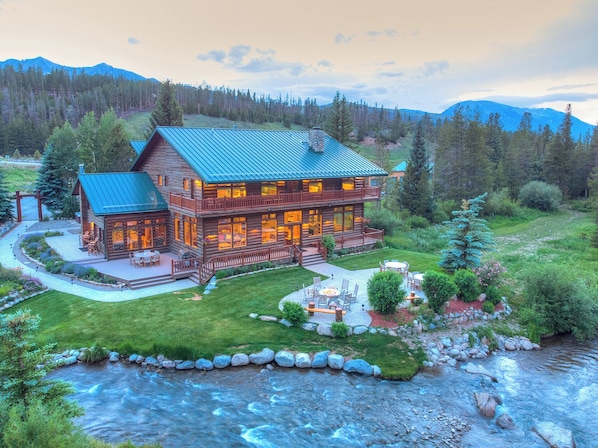 A view of the back lawn, patio and river