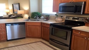 Spacious kitchen with stainless appliances open to dining room and living room