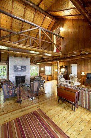 Living Room, wood burning fireplace, open area, unique open 12' bridge above.