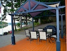 Outdoor dining gazebo with gas grill.